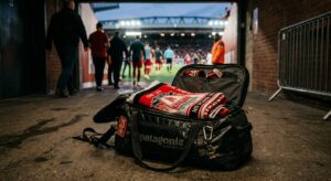 A professional editorial photograph of a folded football supporters' flag carefully packed inside a